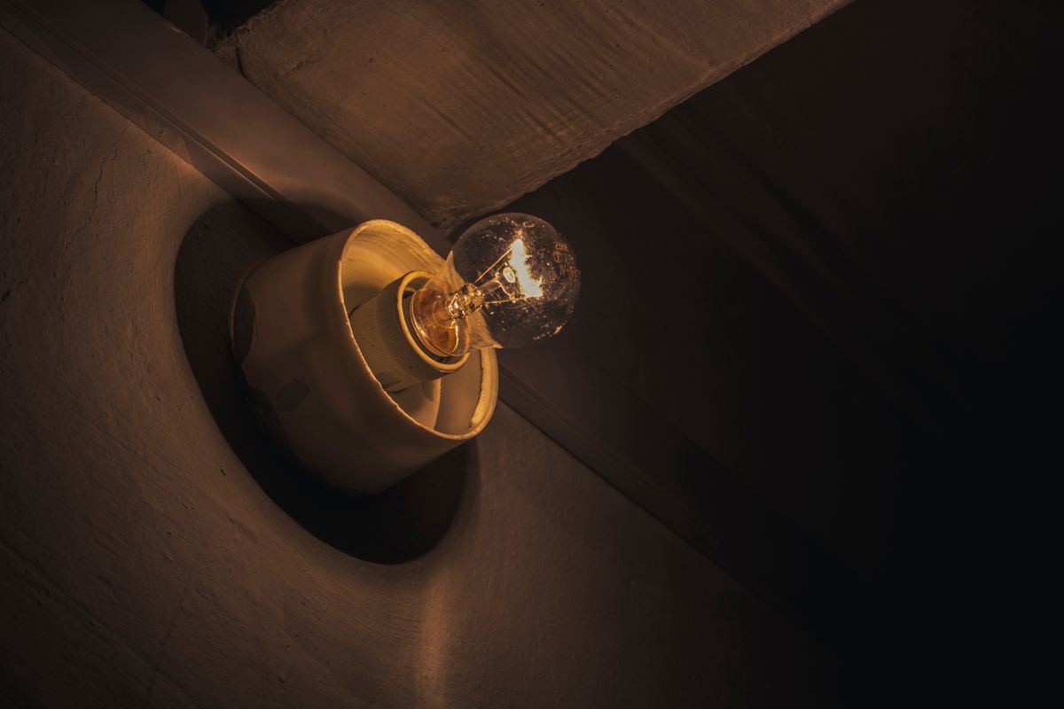 A bare filament bulb glowing warm