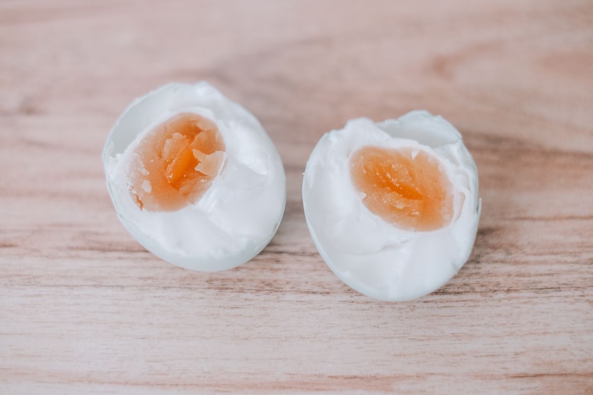 Boiled quail eggs cut in half to show the yolk