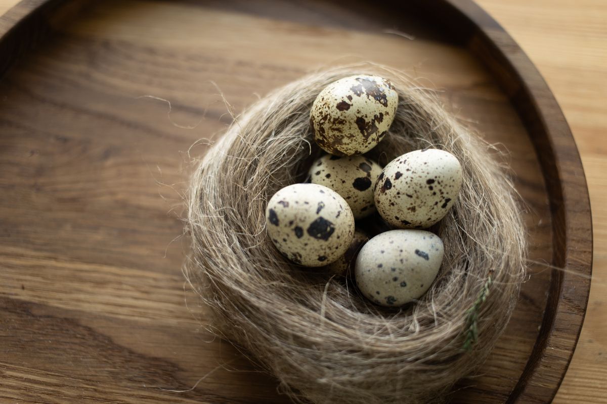 Quail eggs in a woven bowl