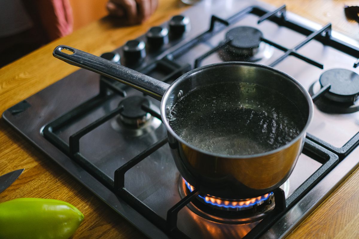 Water at a rolling boil in a steel pan
